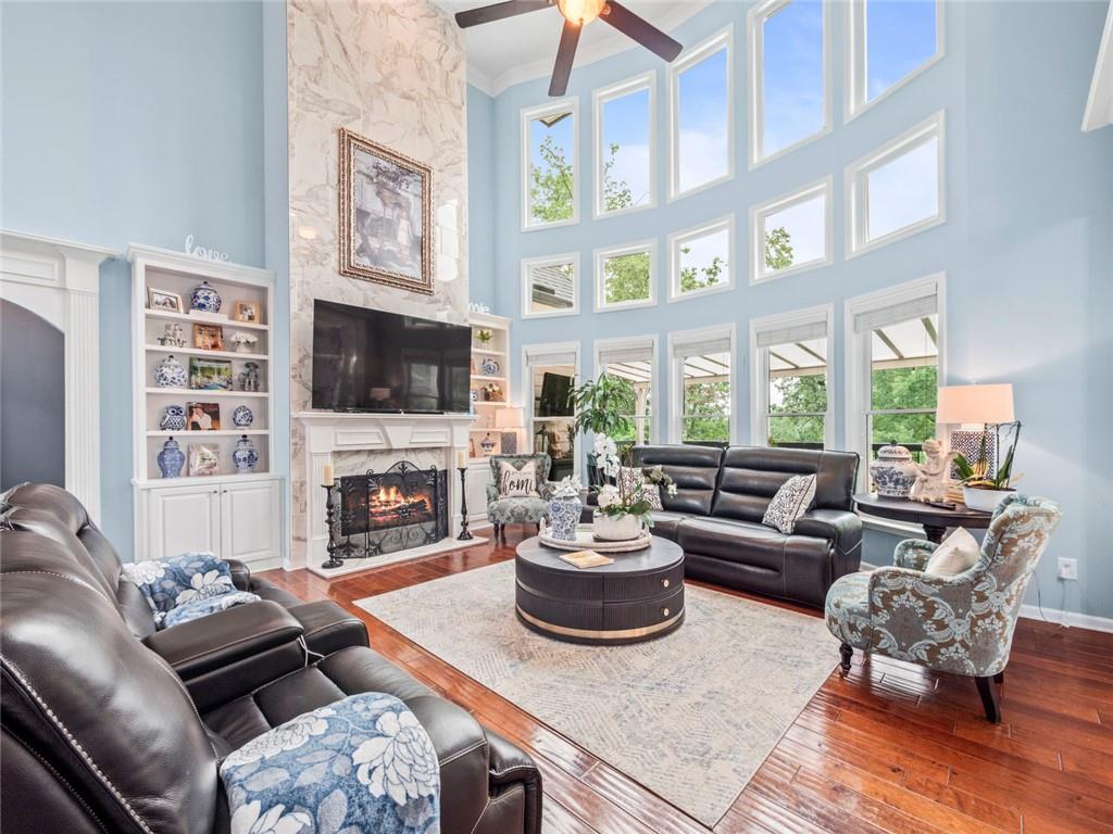 7060 Summit Ridge Chase Cumming, GA 30041 - Photo 49 of 58 a living room with furniture a fireplace and a flat screen tv