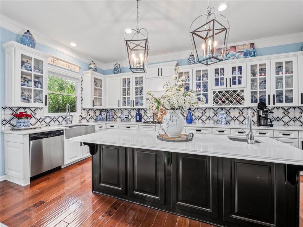 7060 Summit Ridge Chase Cumming, GA 30041 - Photo 52 of 58 a kitchen with stainless steel appliances kitchen island granite countertop a sink and cabinets