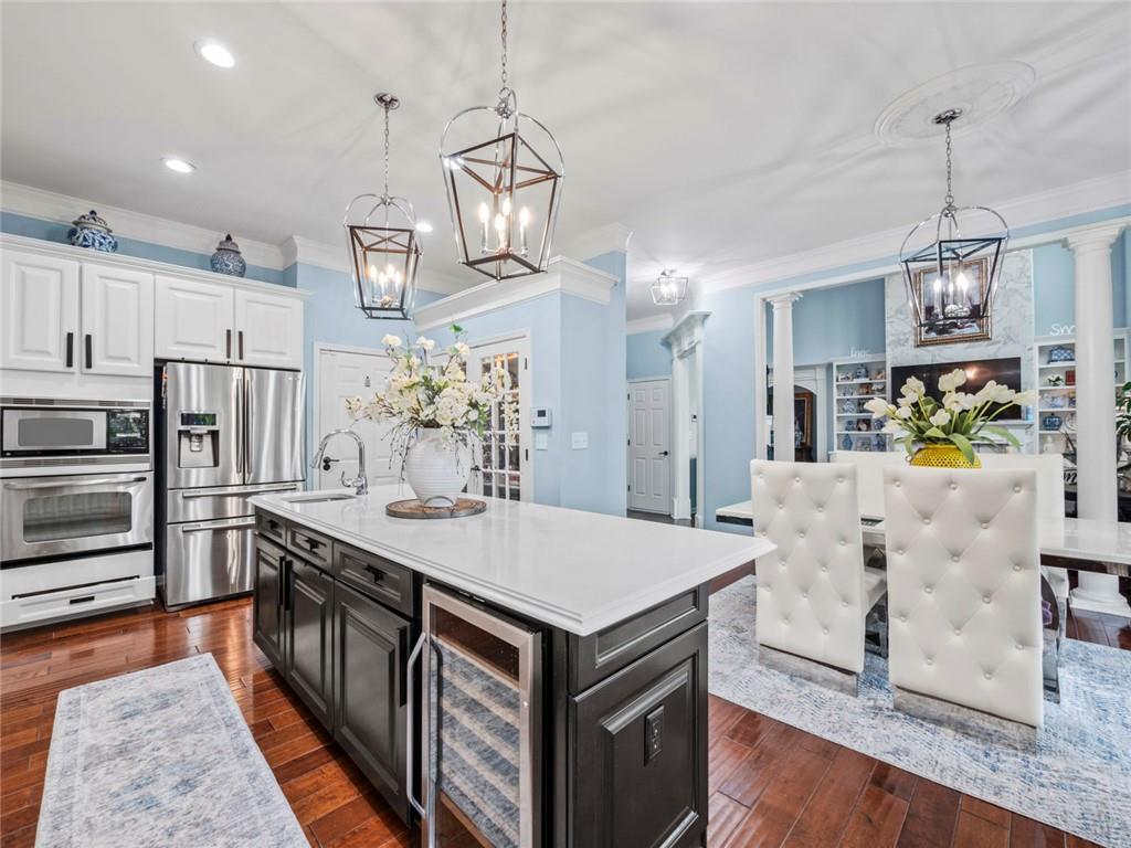 7060 Summit Ridge Chase Cumming, GA 30041 - Photo 55 of 58 a kitchen with stainless steel appliances kitchen island granite countertop a refrigerator a stove top oven a sink and dishwasher