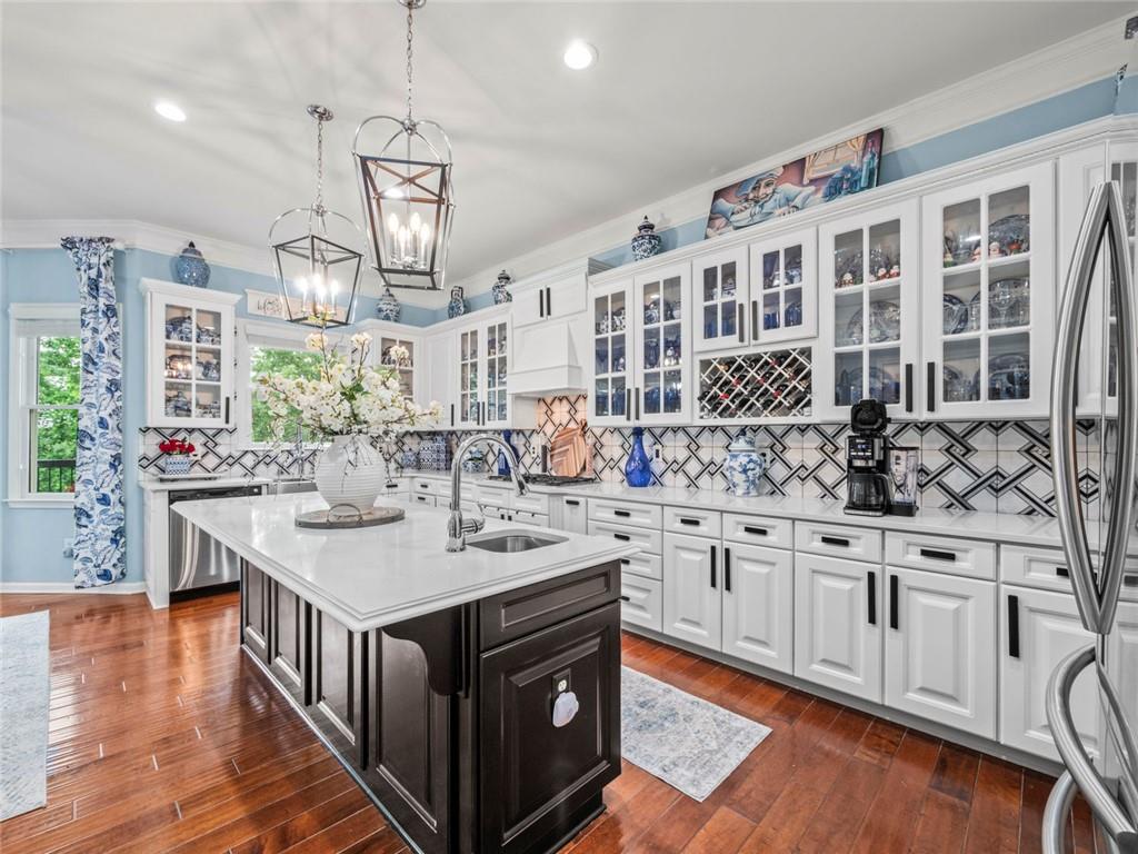7060 Summit Ridge Chase Cumming, GA 30041 - Photo 57 of 58 a kitchen with stainless steel appliances granite countertop a sink and stove