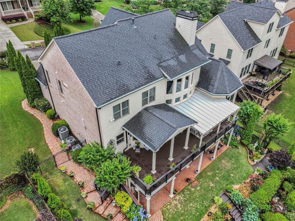 7060 Summit Ridge Chase Cumming, GA 30041 - Photo 6 of 58 an aerial view of a house with a big yard and large trees