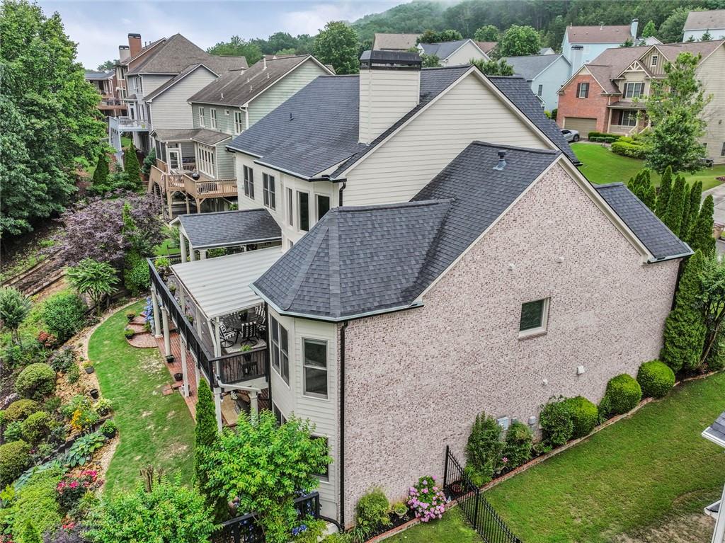 7060 Summit Ridge Chase Cumming, GA 30041 - Photo 7 of 58 an aerial view of a house with yard and trees in the background
