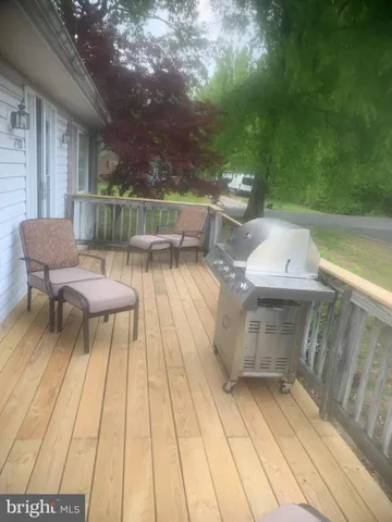 a balcony with chairs and with wooden floor