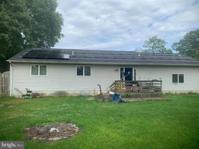 a front view of house with yard and outdoor seating