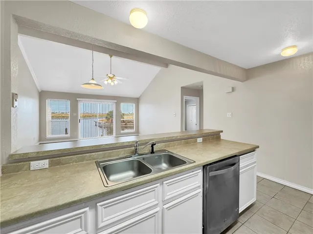 a kitchen with a sink and chandelier