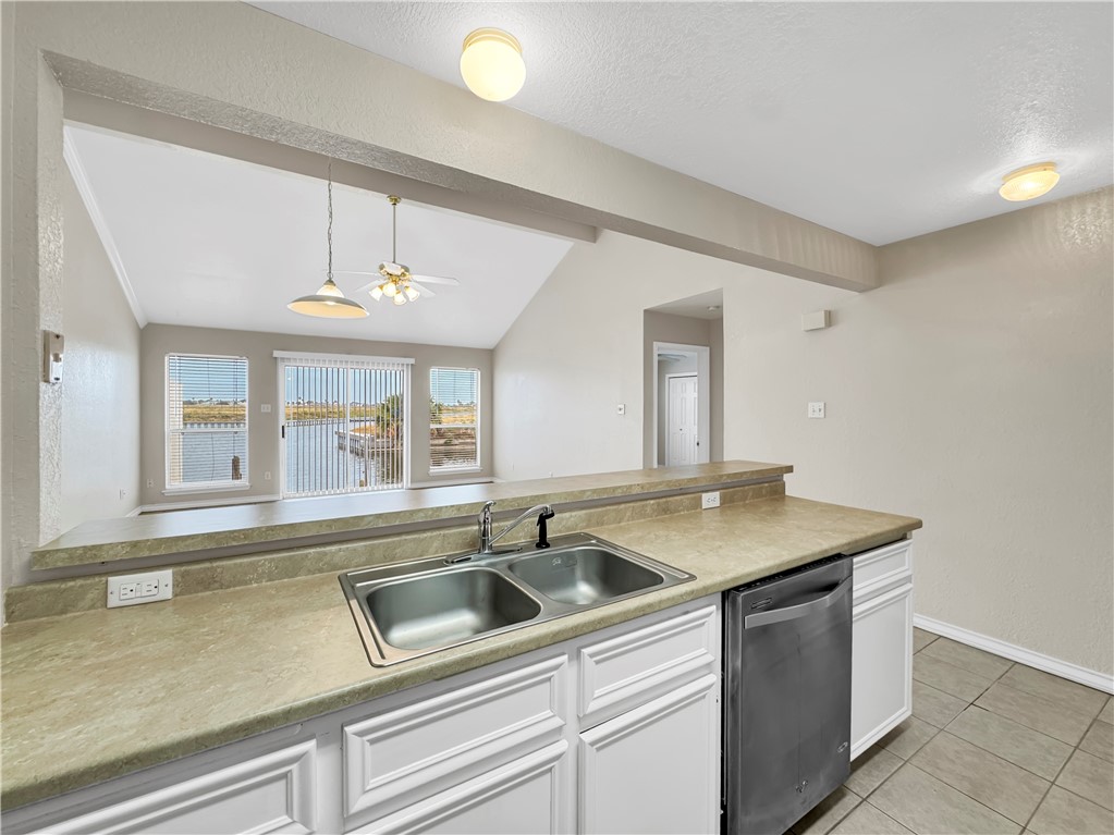 14302 Cruiser Street, Unit B Corpus Christi, TX 78418 - Photo 13 of 25 a kitchen with a sink and chandelier