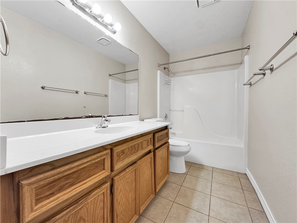14302 Cruiser Street, Unit B Corpus Christi, TX 78418 - Photo 19 of 25 a bathroom with a sink a toilet and shower