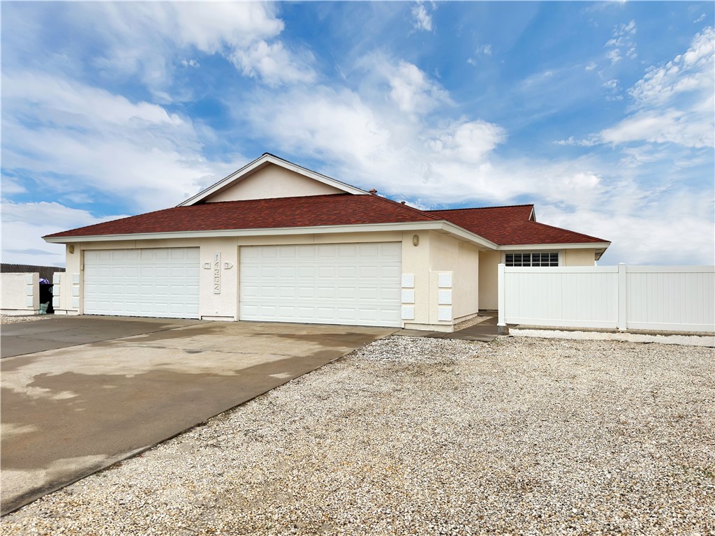 14302 Cruiser Street, Unit B Corpus Christi, TX 78418 - Photo 2 of 25 a front view of a house with a yard and garage
