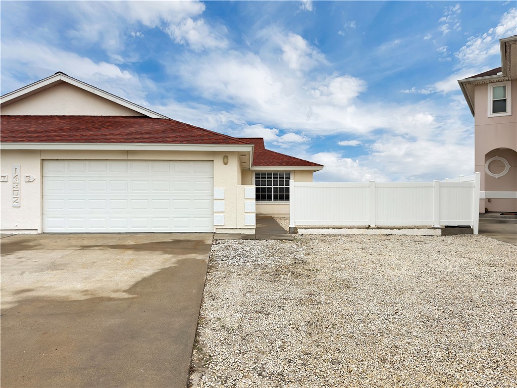 14302 Cruiser Street, Unit B Corpus Christi, TX 78418 - Photo 4 of 25 a view of a house with a yard and garage