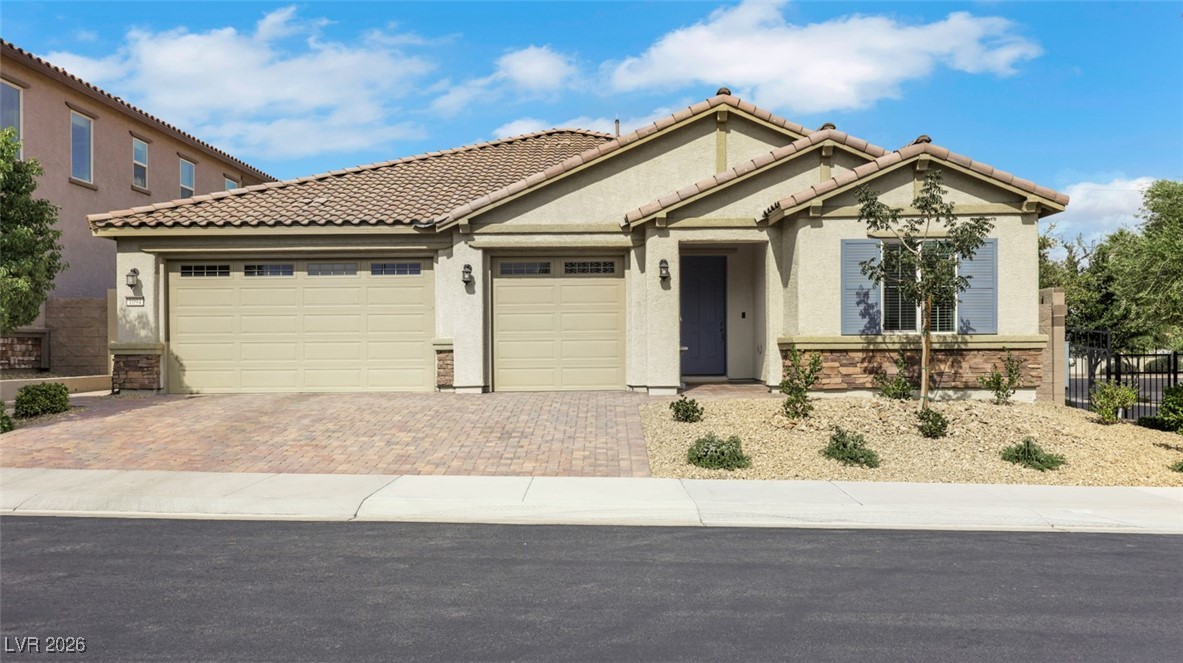 1094 Langston Ranch Avenue Henderson, NV 89002 - Photo 10 of 70 View of front facade with stucco siding, decorative driveway, and a garage