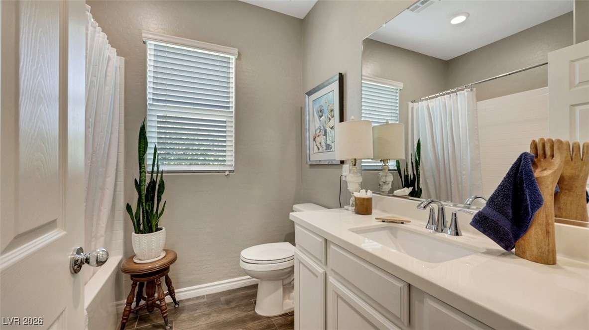 1094 Langston Ranch Avenue Henderson, NV 89002 - Photo 20 of 70 Full bathroom with vanity, a shower with shower curtain, and dark wood finished floors