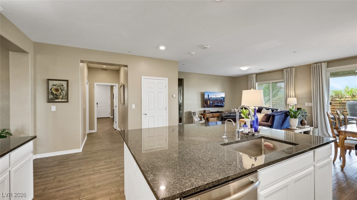 1094 Langston Ranch Avenue Henderson, NV 89002 - Photo 23 of 70 Kitchen with white cabinets, dark wood-style floors, dark stone counters, a kitchen island with sink, and recessed lighting
