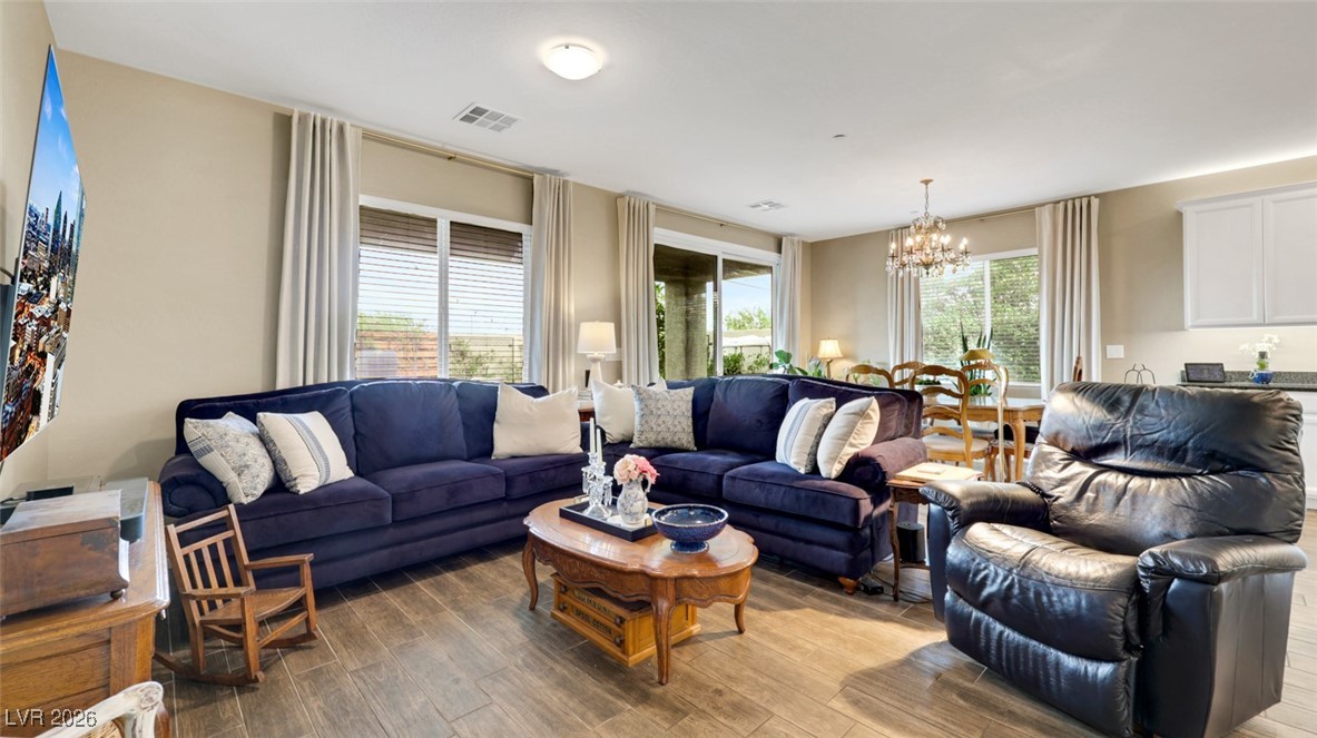 1094 Langston Ranch Avenue Henderson, NV 89002 - Photo 25 of 70 Living area with wood finished floors and a chandelier