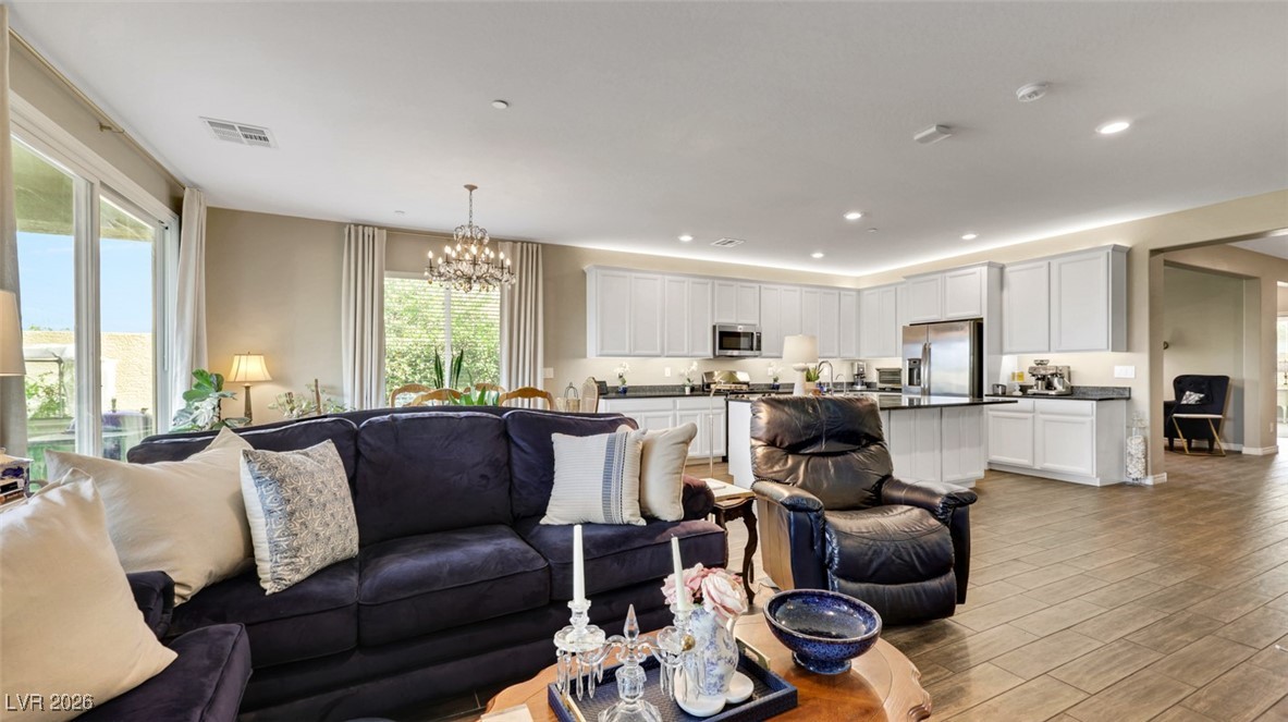 1094 Langston Ranch Avenue Henderson, NV 89002 - Photo 26 of 70 Living area featuring wood tiled floors, a chandelier, and recessed lighting