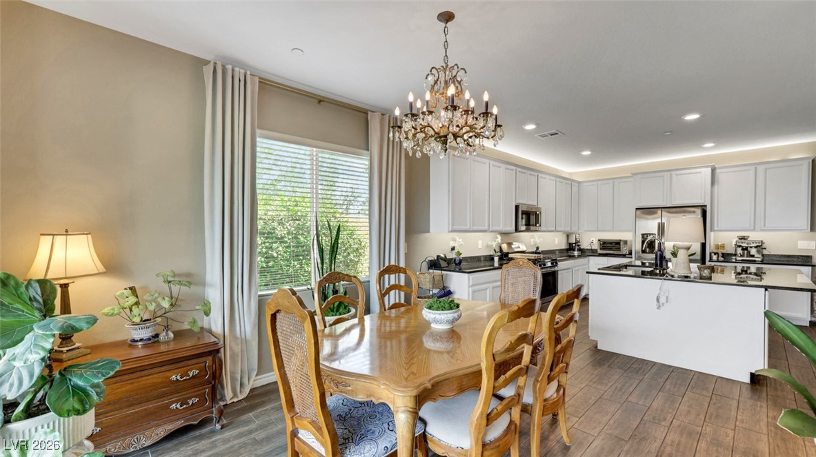 1094 Langston Ranch Avenue Henderson, NV 89002 - Photo 28 of 70 Dining room with wood finish floors, recessed lighting, and a chandelier