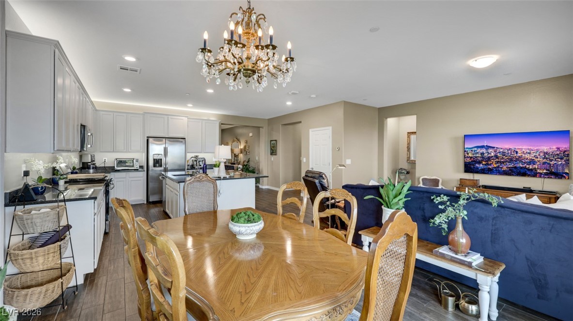 1094 Langston Ranch Avenue Henderson, NV 89002 - Photo 31 of 70 Dining area with dark wood finished floors, recessed lighting, and a chandelier
