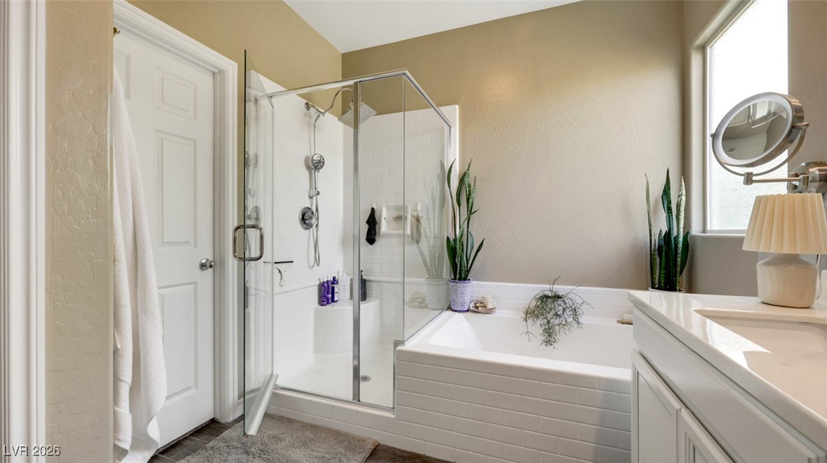 1094 Langston Ranch Avenue Henderson, NV 89002 - Photo 47 of 70 Bathroom featuring vanity, a garden tub, and a shower stall