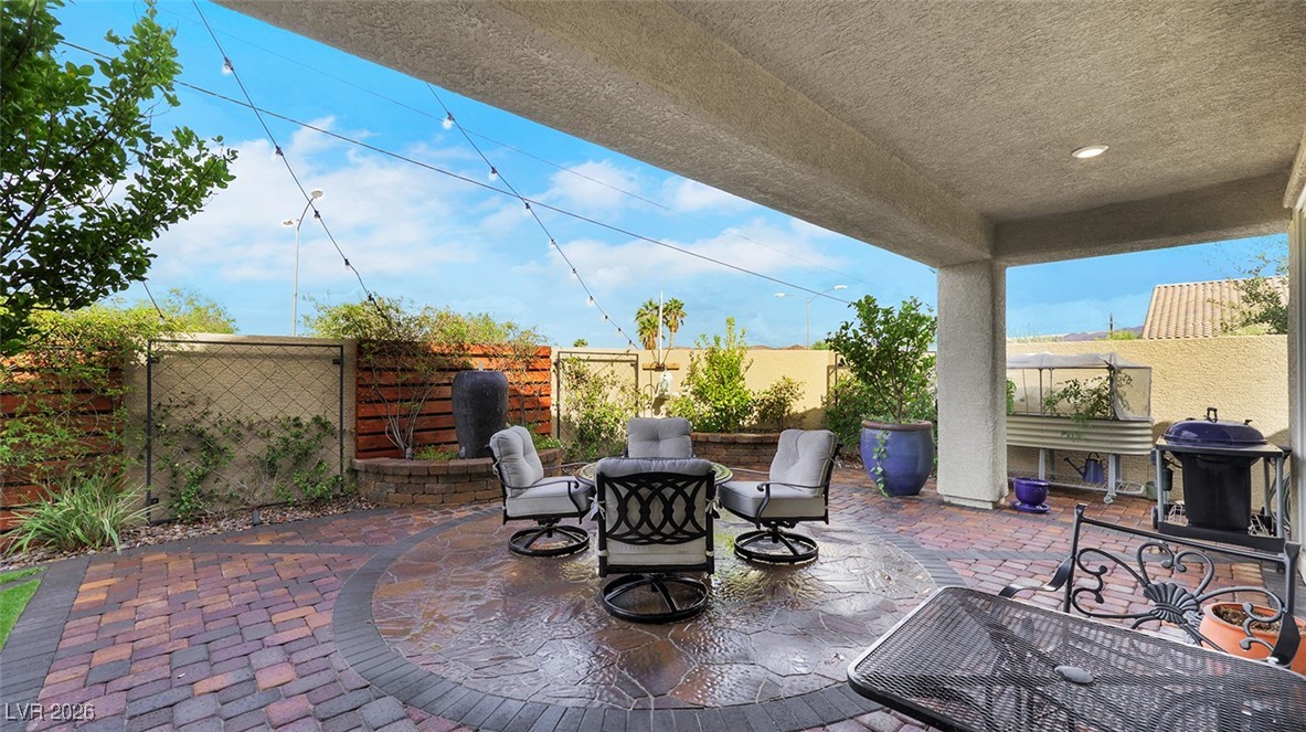 1094 Langston Ranch Avenue Henderson, NV 89002 - Photo 51 of 70 Fenced backyard with a patio area, a grill, and an outdoor fire pit