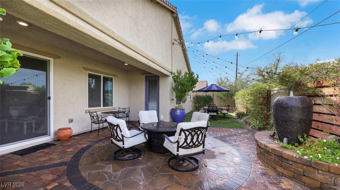 1094 Langston Ranch Avenue Henderson, NV 89002 - Photo 52 of 70 Fenced backyard featuring a fire pit, a patio, and outdoor dining space