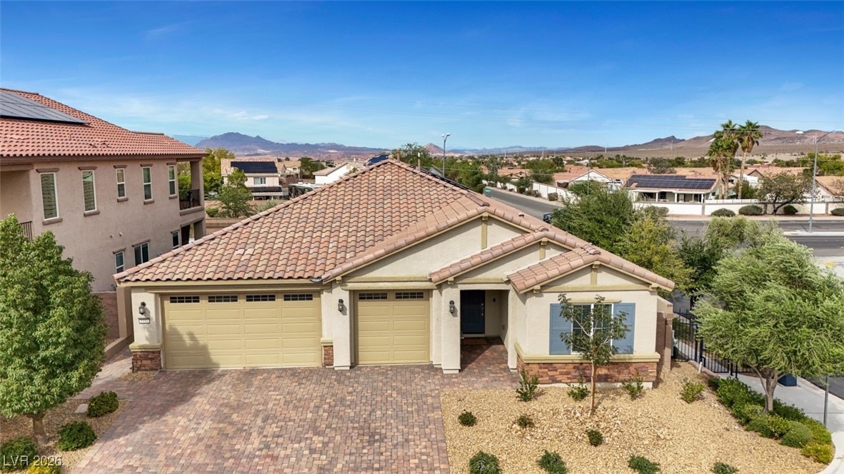 1094 Langston Ranch Avenue Henderson, NV 89002 - Photo 8 of 70 View of front of house with stucco siding, decorative driveway, a residential view, and stone siding