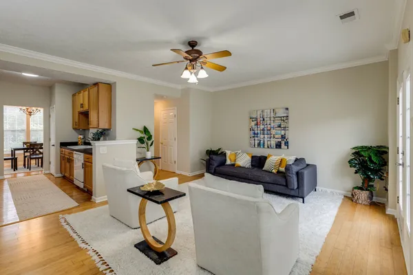 a living room with furniture and a chandelier