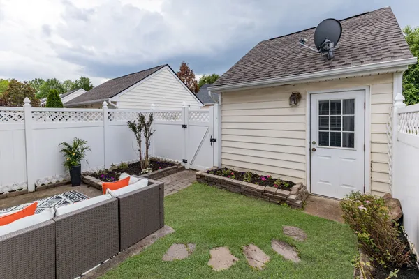 a backyard of a house with wooden floor barbeque oven and yard
