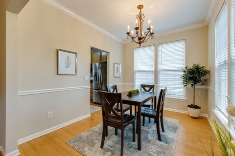 a view of a dining room with furniture and window