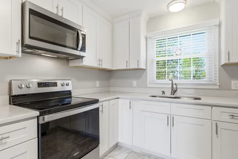 a kitchen with a stove microwave and sink