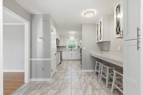 a kitchen with stainless steel appliances granite countertop a refrigerator and a sink