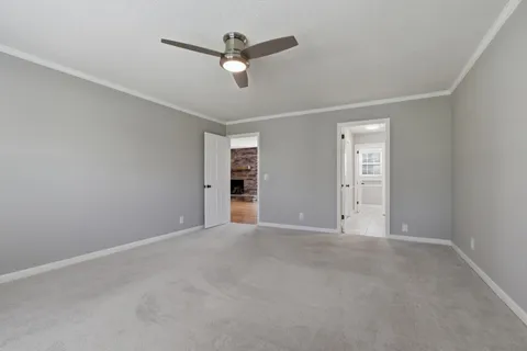 an empty room with closet and fan