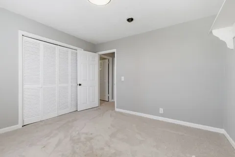 a bathroom with white cabinets