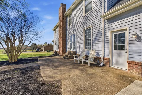 a front view of a house with a garden and yard
