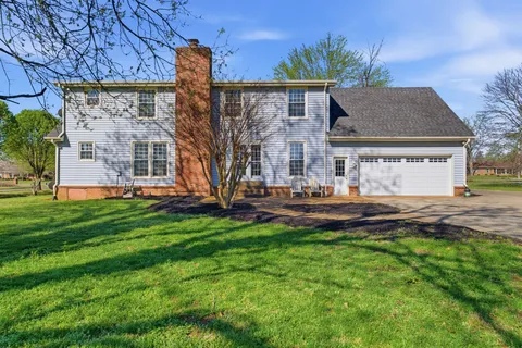 a view of a house with backyard and garden
