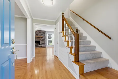 a view of entryway and hall with wooden floor