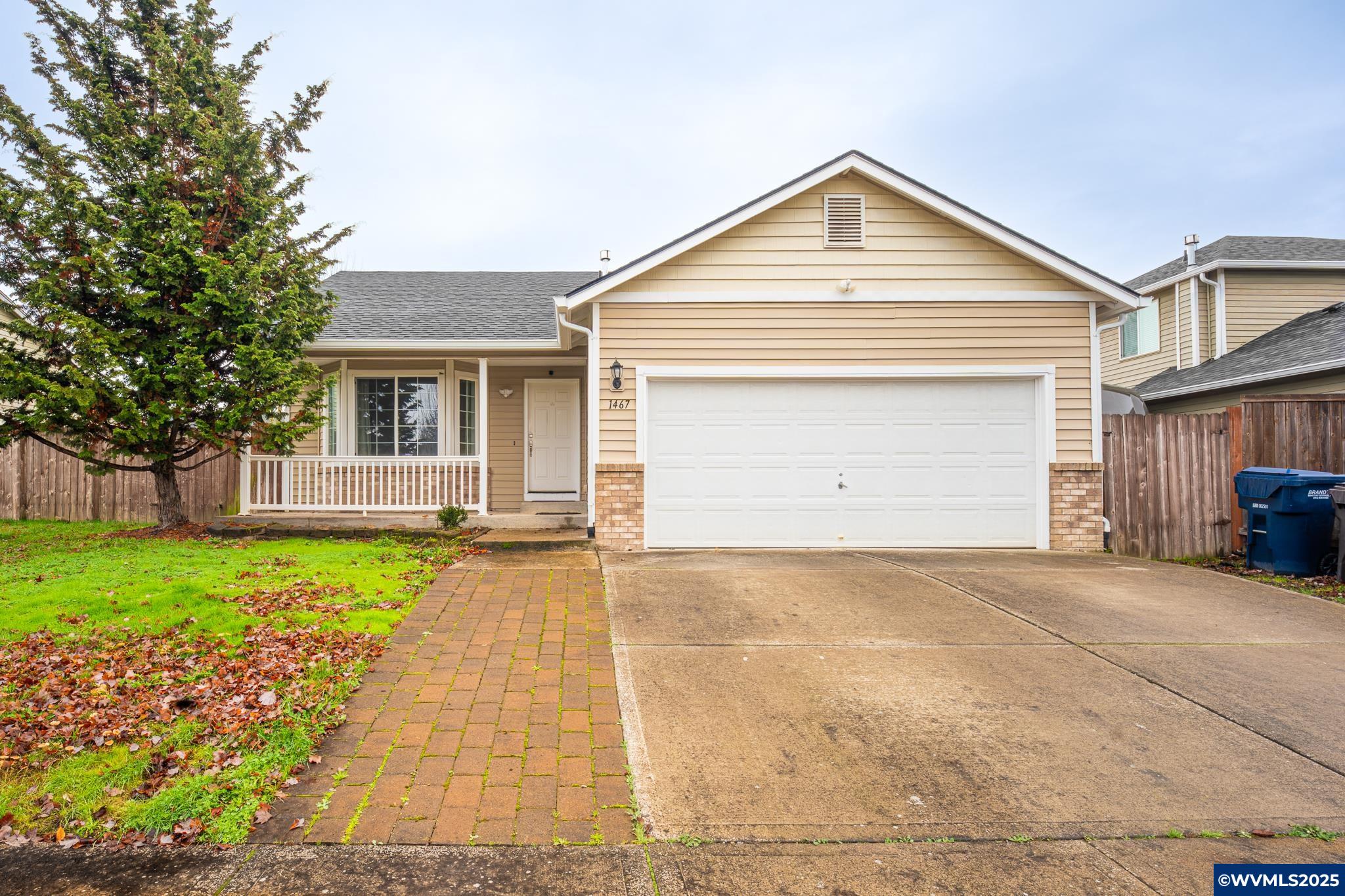 1467 South 7th Street Independence, OR 97351 - Photo 1 of 31 a front view of a house with a yard and garage
