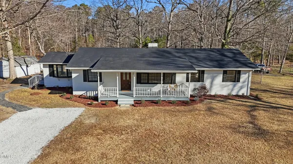 a house view with a sitting space and wooden fence