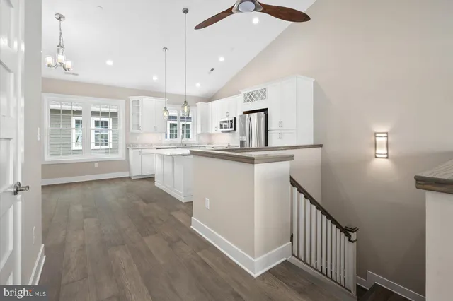 a view of a kitchen with furniture and wooden floor