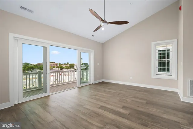 a view of a livingroom with wooden floor and a ceiling fan