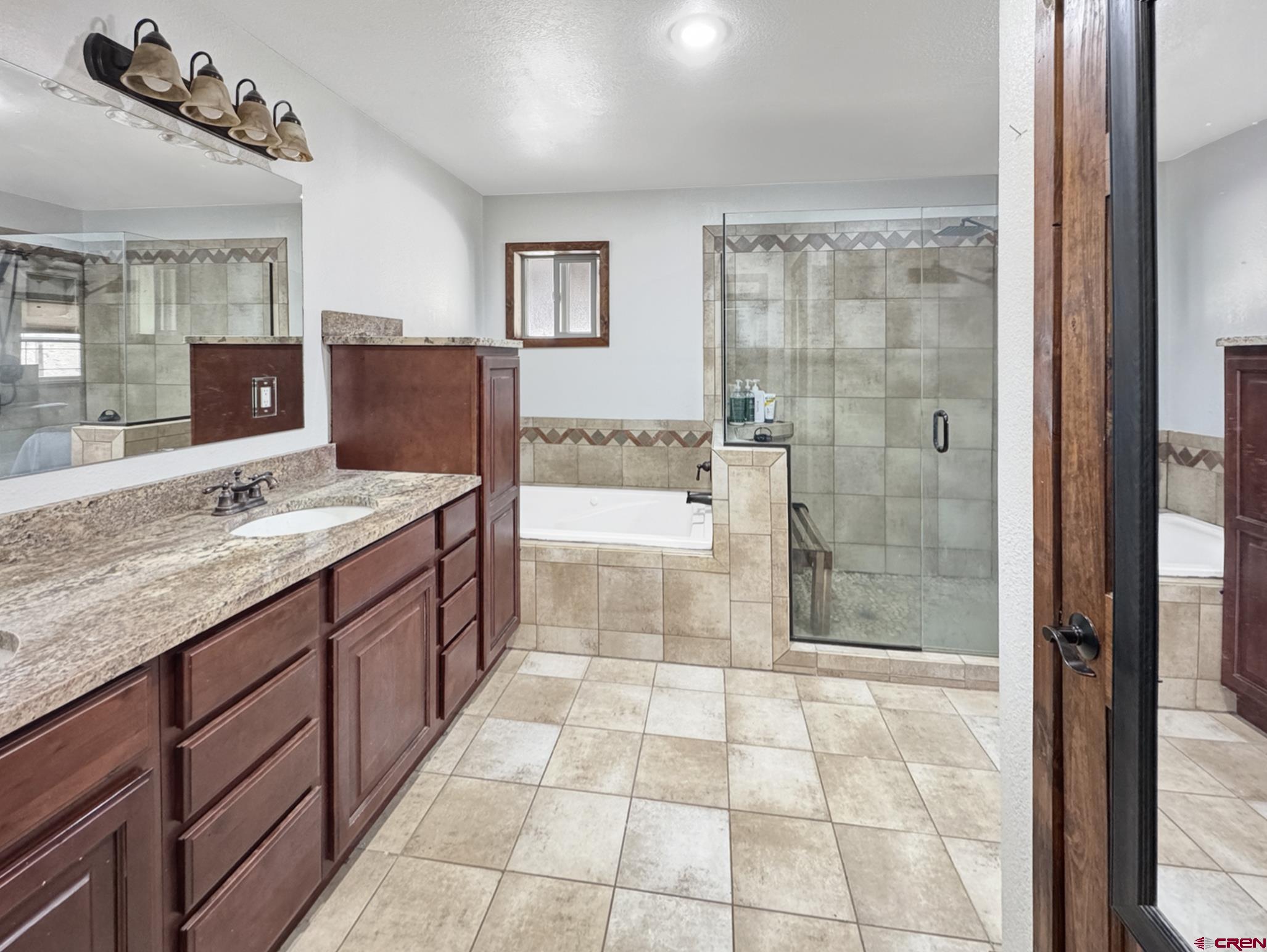 9159 Highway 65 Austin, CO 81410 - Photo 1 of 33 a spacious bathroom with a granite countertop sink a mirror and a shower