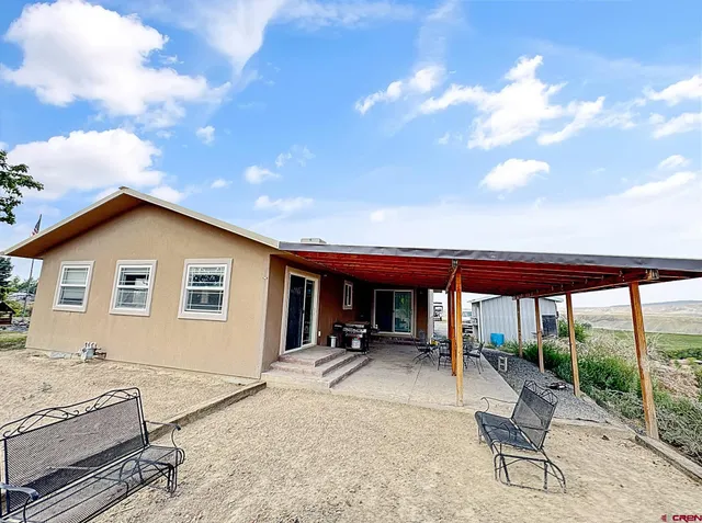 a backyard of a house with yard barbeque oven and outdoor seating