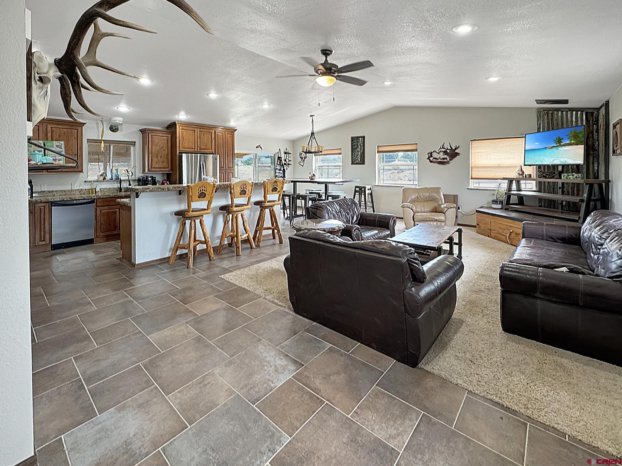 9159 Highway 65 Austin, CO 81410 - Photo 27 of 33 a living room with lots of furniture and kitchen view