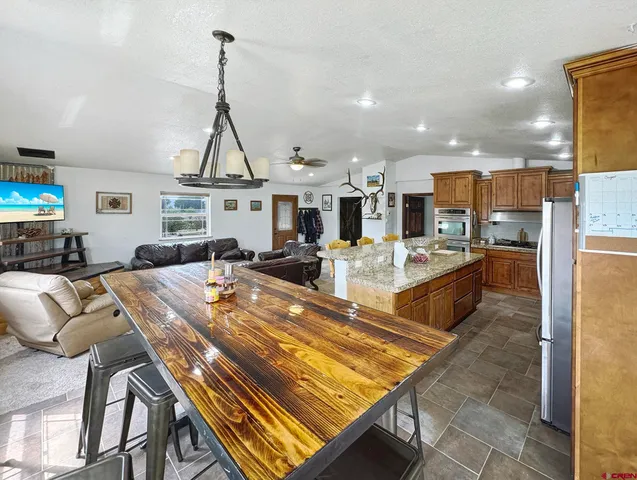 a living room with lots of furniture and kitchen view