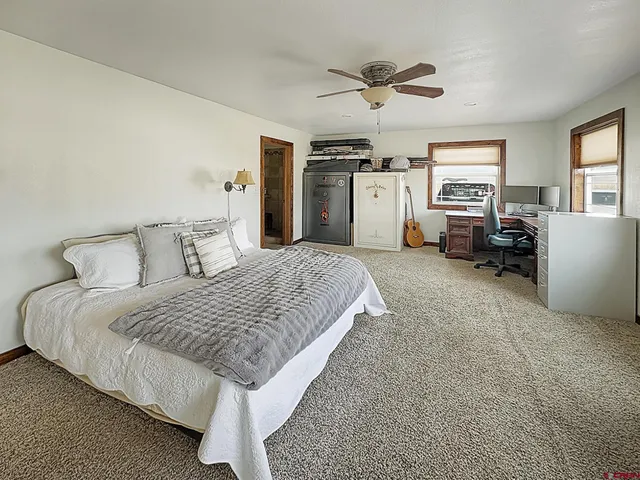 a spacious bedroom with a bed couch and a window
