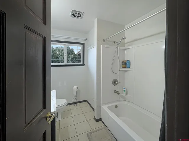 a bathroom with a bathtub and shower