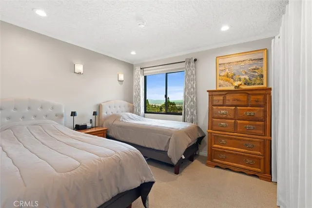 a work room with furniture a window and a flat screen tv