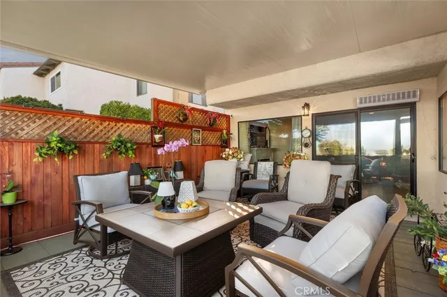 a dining room with furniture a rug and wooden floor
