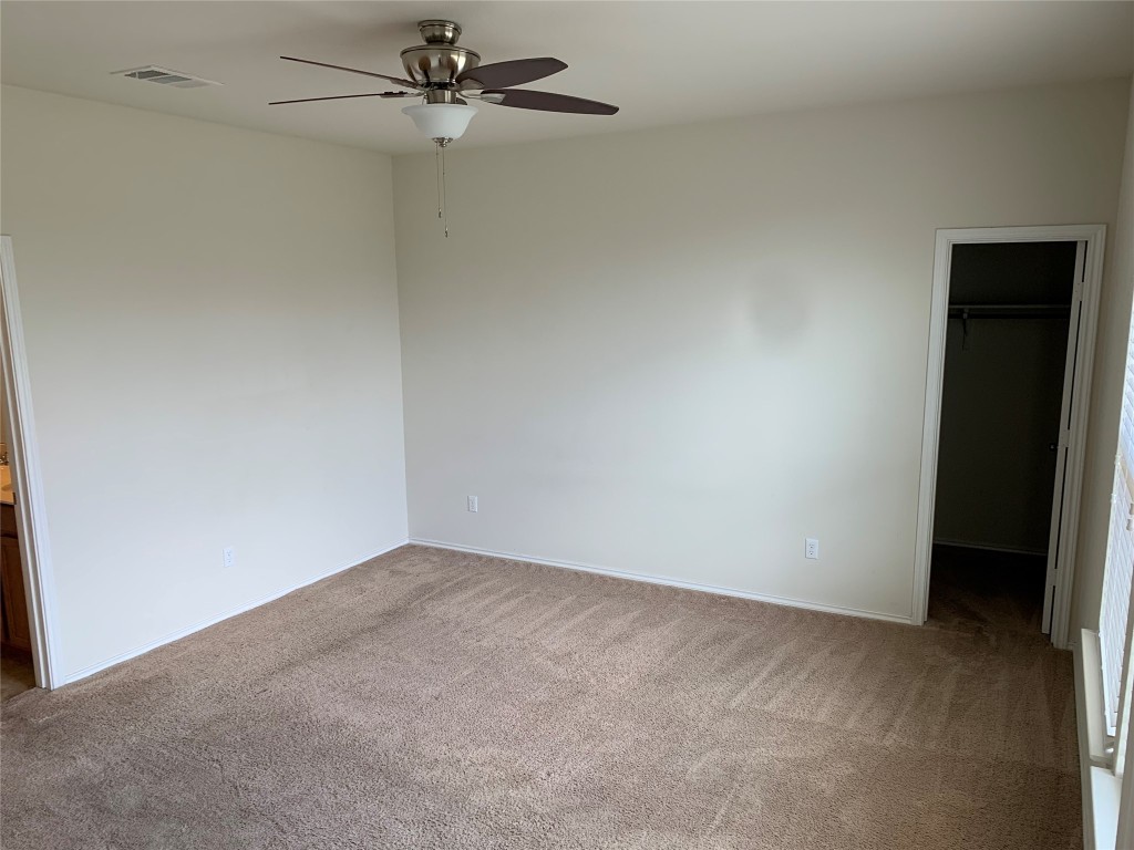 113 Sierra Mar Loop Leander, TX 78641 - Photo 11 of 22 an empty room with a ceiling fan and carpet