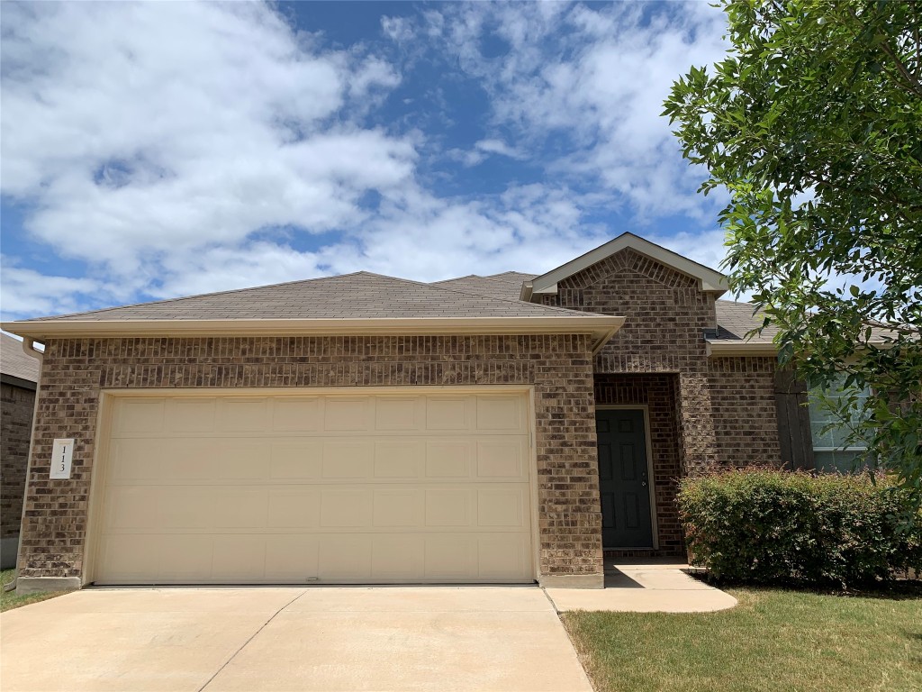 113 Sierra Mar Loop Leander, TX 78641 - Photo 2 of 22 a front view of a house with a garden