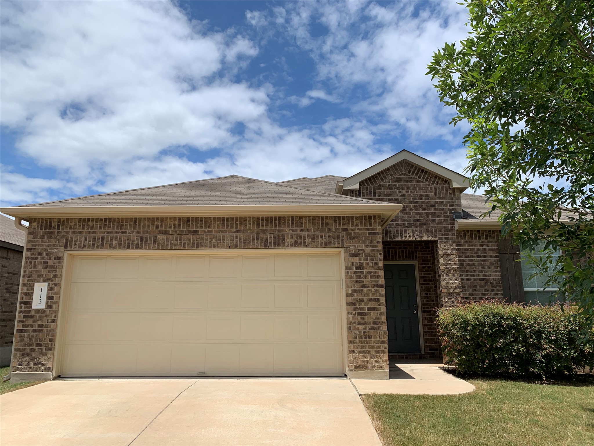 113 Sierra Mar Loop Leander, TX 78641 - Photo 2 of 22 a front view of a house with a garden