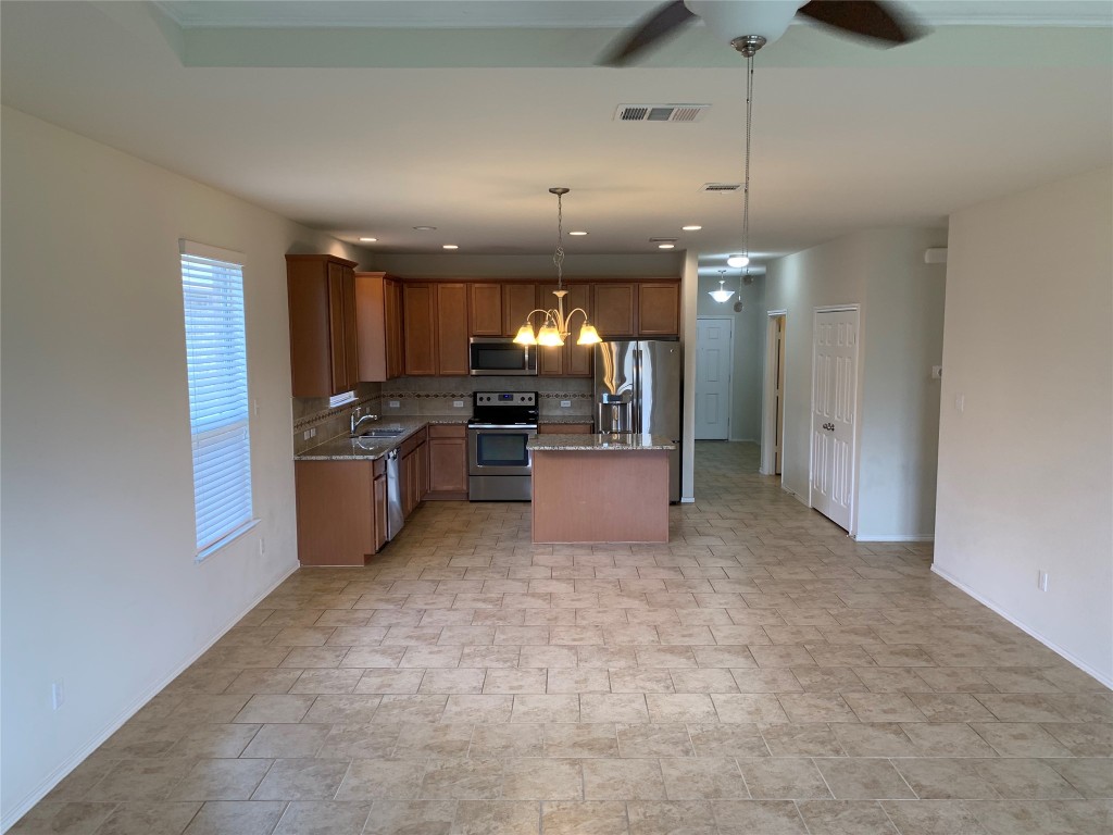113 Sierra Mar Loop Leander, TX 78641 - Photo 10 of 22 a large kitchen with cabinets and stainless steel appliances
